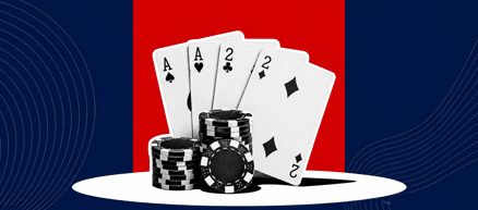 two aces and two 2s behind a chip stack