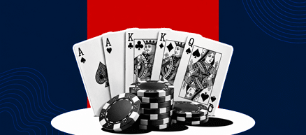 5 playing cards behind a stack of chips