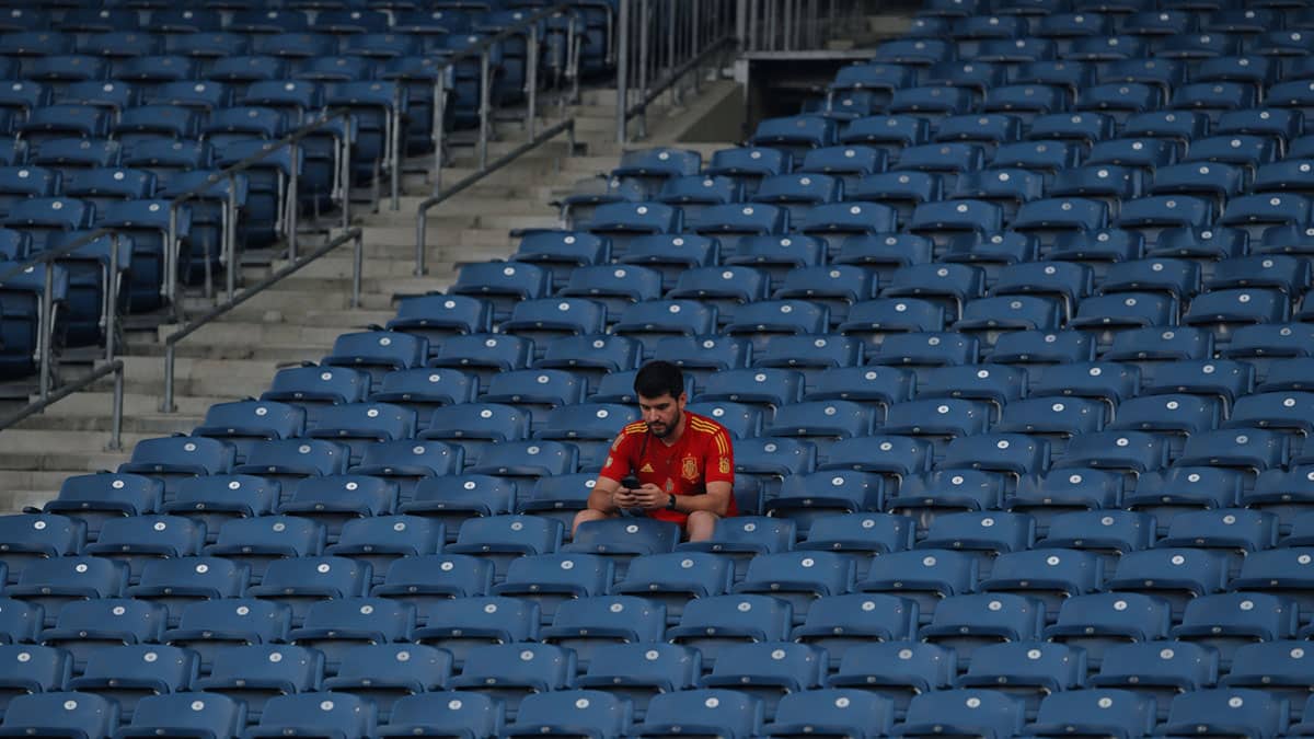Spanish Soccer Fan Betting Phone Empty Stadium